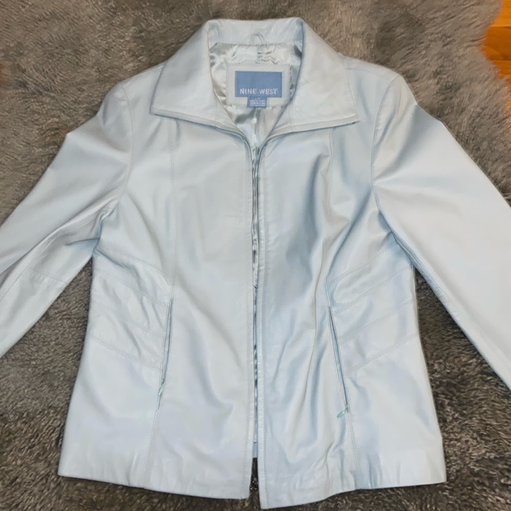 Light blue color short leather jacket with two front zipper pockets